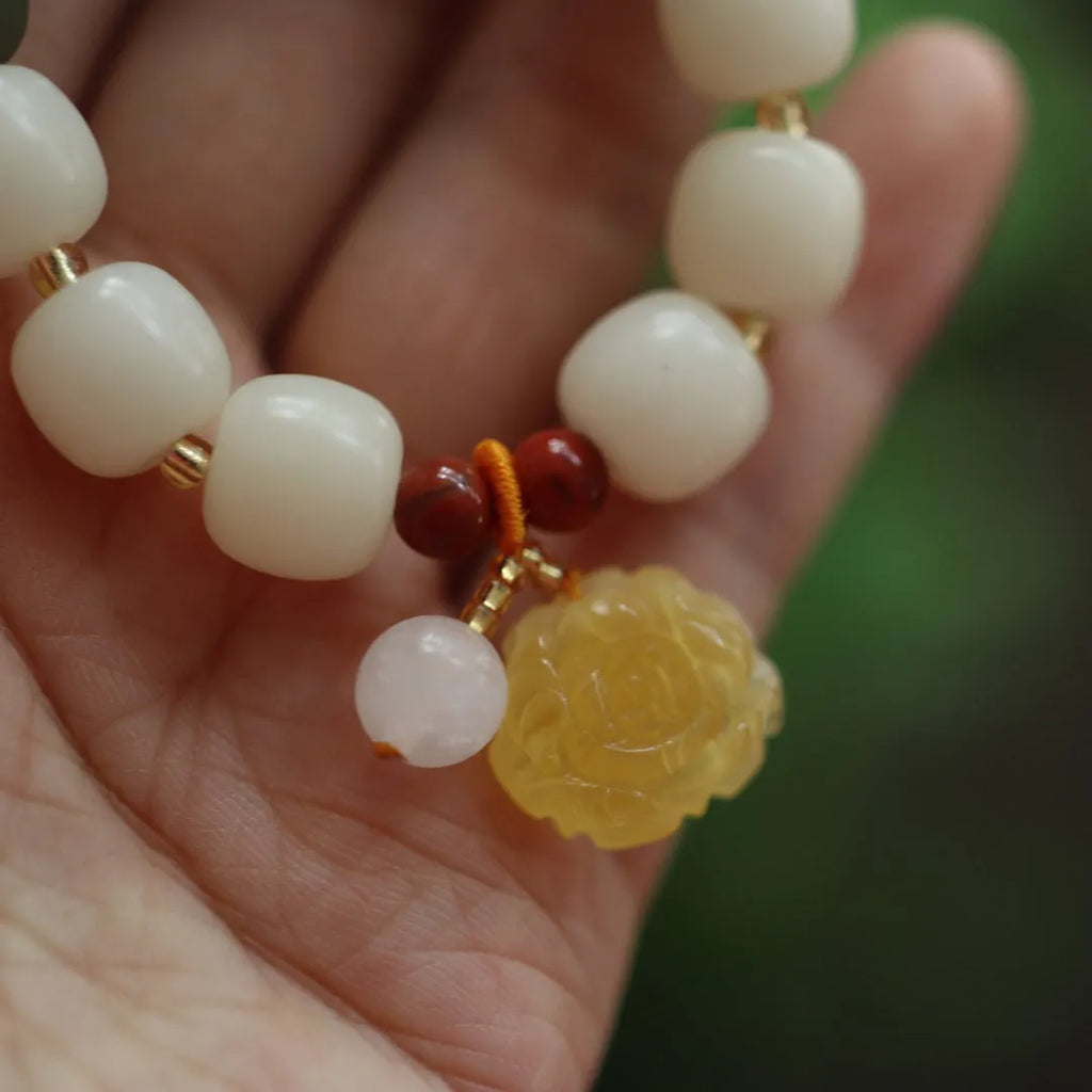 Women's handwoven bracelet with gradient White Jade beads and beeswax Lotus pendant on Bodhi root