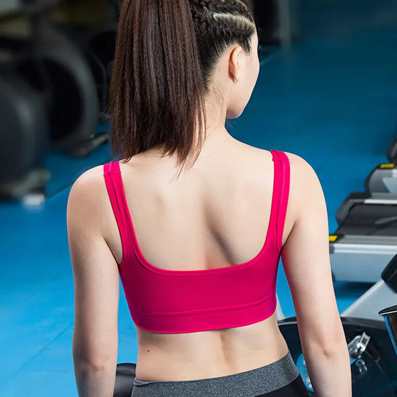 Women's pink sports bra with thin moulded cups and fixed double shoulder straps.