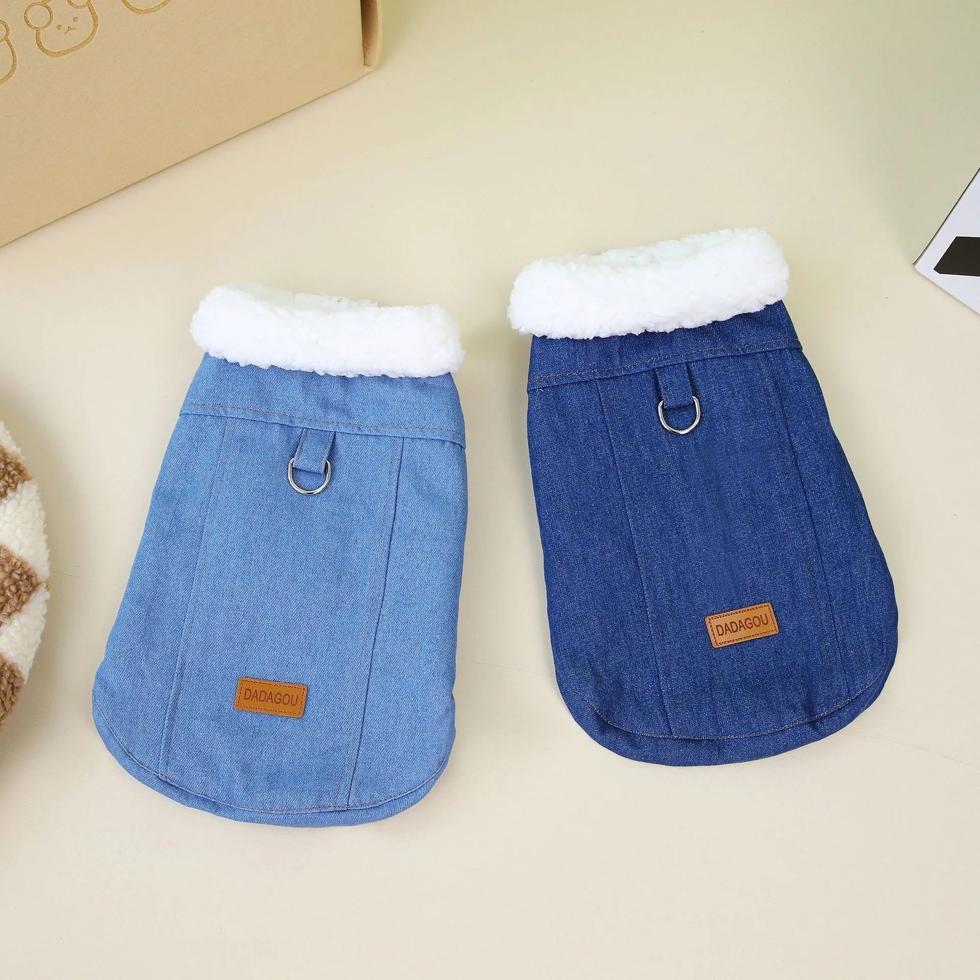 Corgi dog wearing dark blue denim cotton coat with size label visible