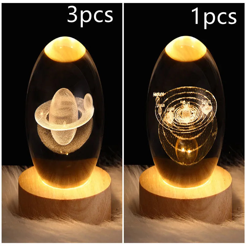 LED galaxy crystal ball night light with 3D planet designs on a table