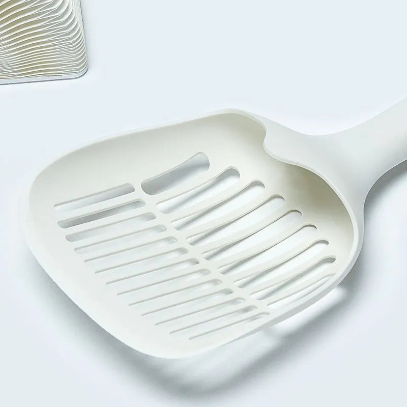 White plastic cat litter scoop with attached storage base on a white background.