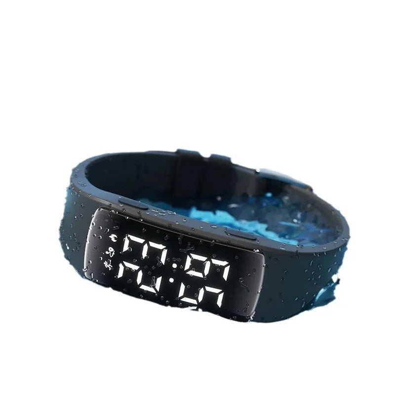 Vibration alarm smart watch with coloured silicone strap on a wrist, showing LED display.