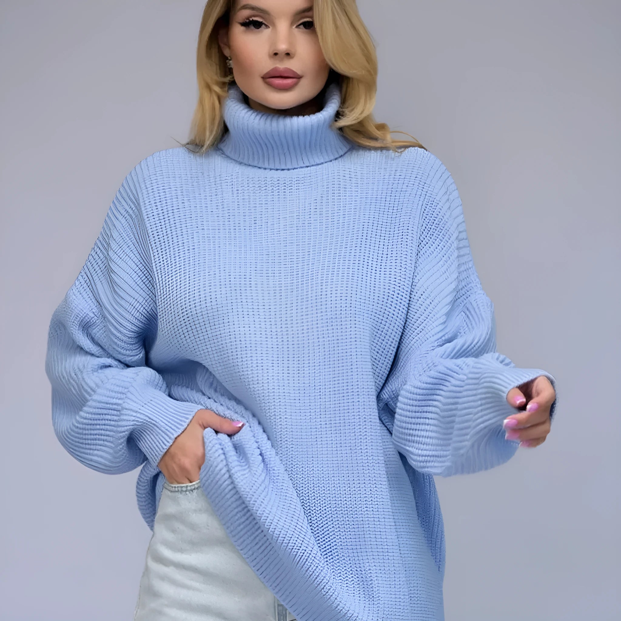 Women's solid colour high neck pullover sweater in a loose fit, shown in sky blue.