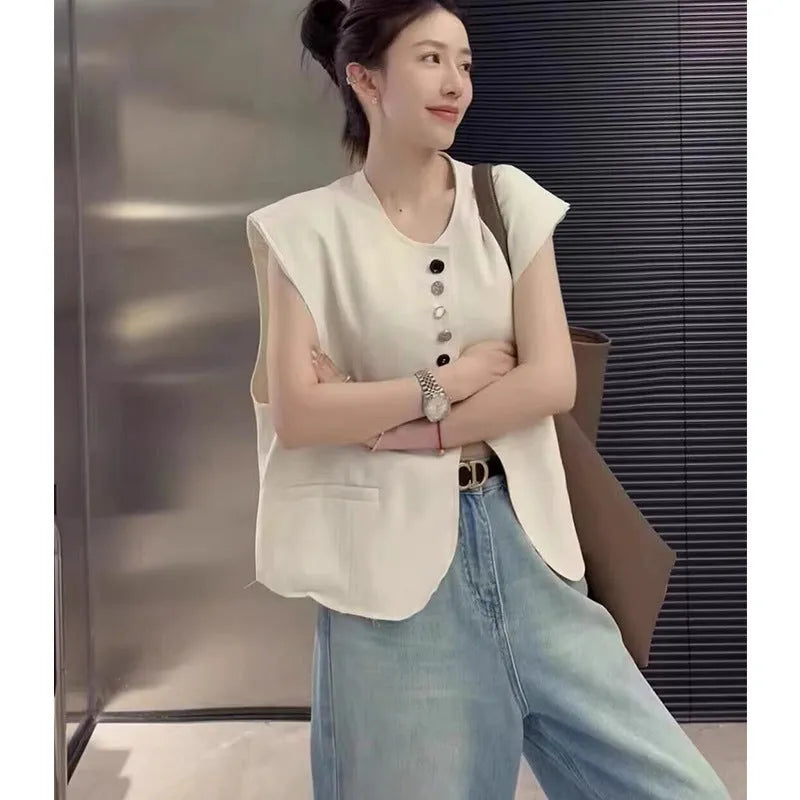 Women's loose-fit short polyester vest in milky white with a pocket, shown on a hanger.