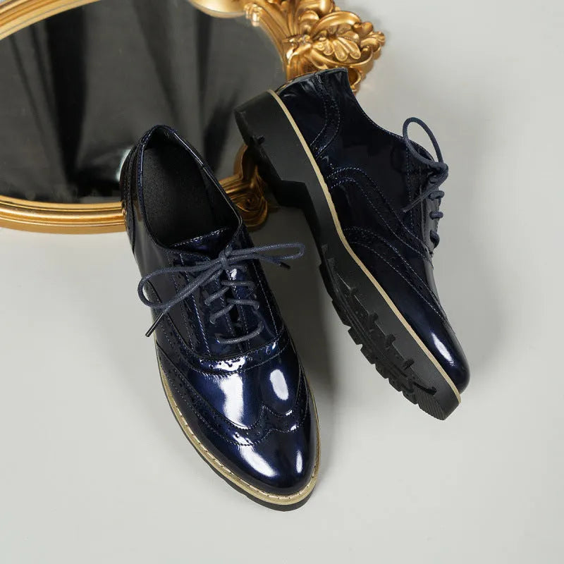 Women's black lace-up loafers with wedge heel and sequin details on the upper.