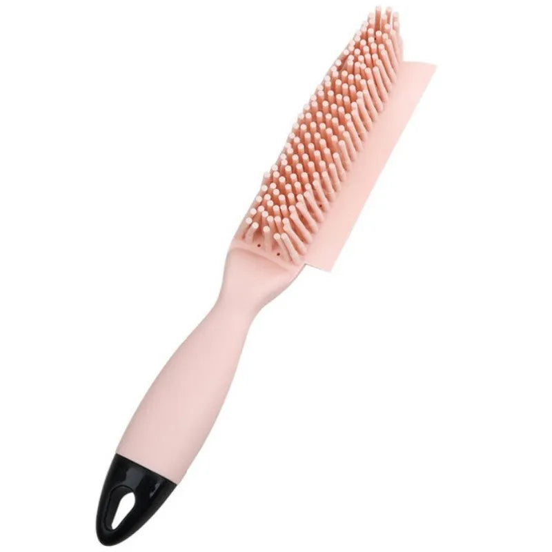 Pink and green handheld pet hair remover brush with grooming comb and integrated clothes hair collector.