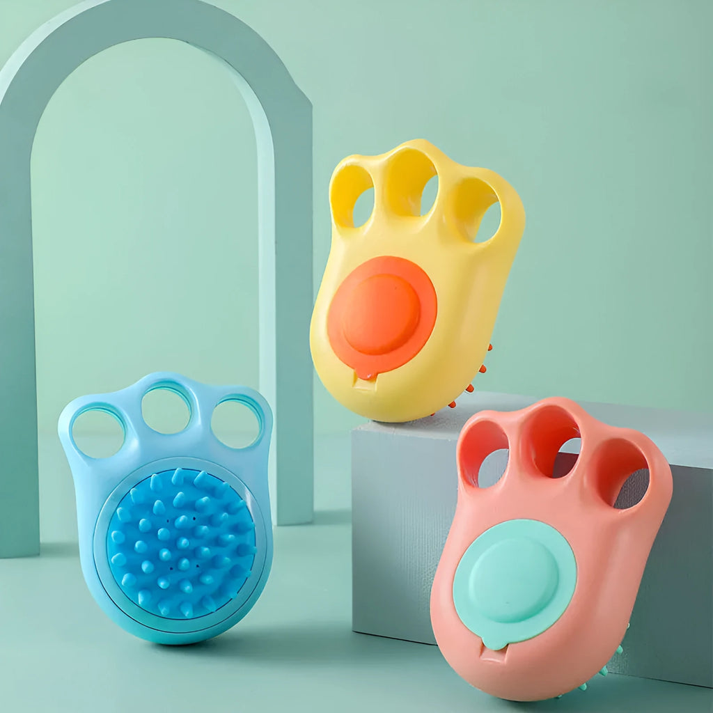 Blue silicone claw-shaped pet bath brush with flexible bristles for washing cats and dogs.