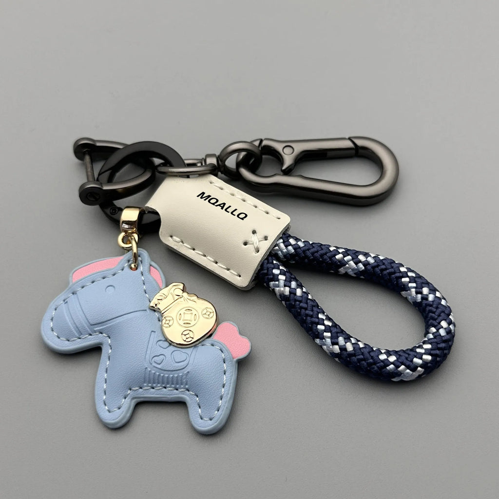 Handmade brown cowhide leather keychain with a silver pony belt buckle charm and green velvet rope.