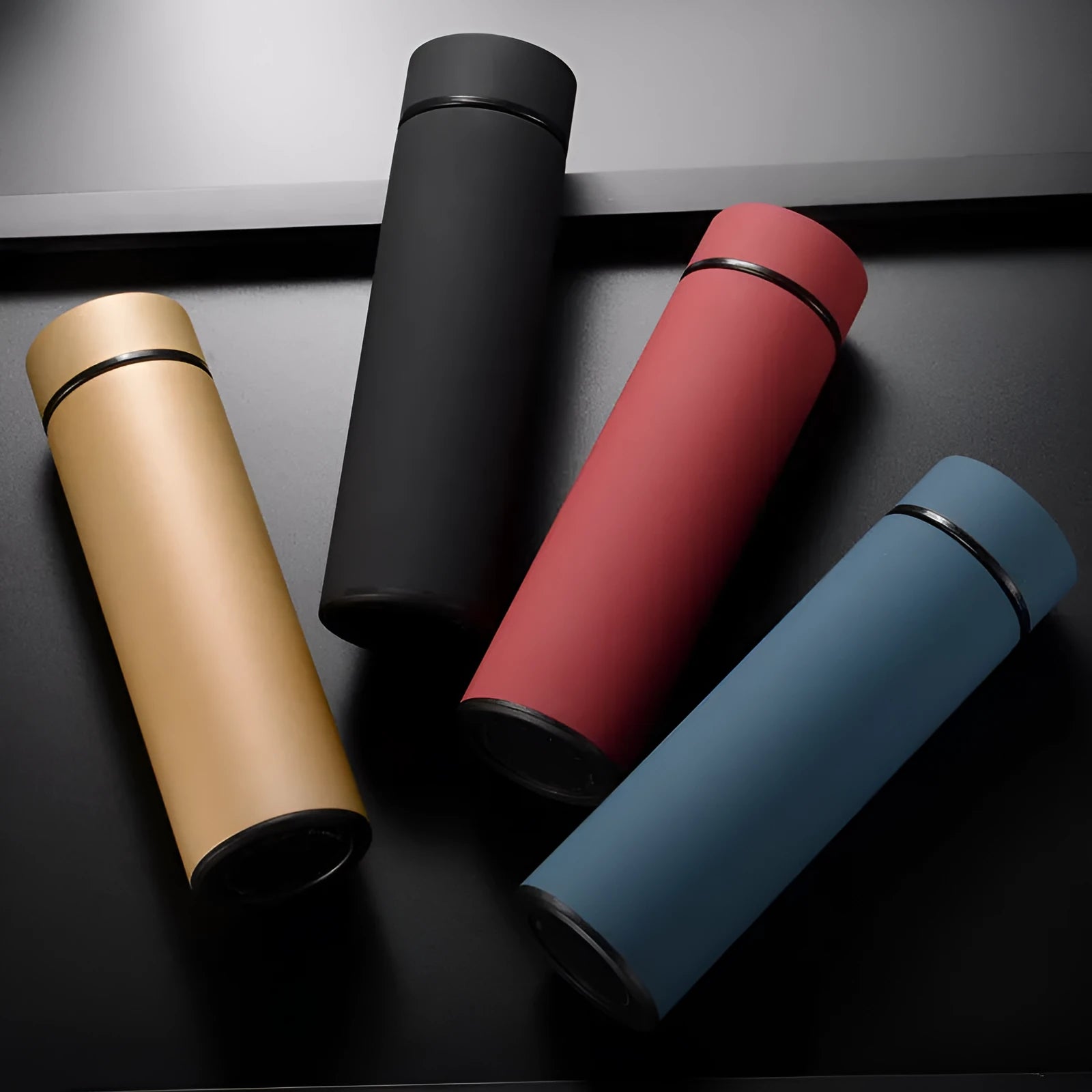 Straight style stainless steel water bottle with double-wall vacuum insulation in black, red, gold, or blue.