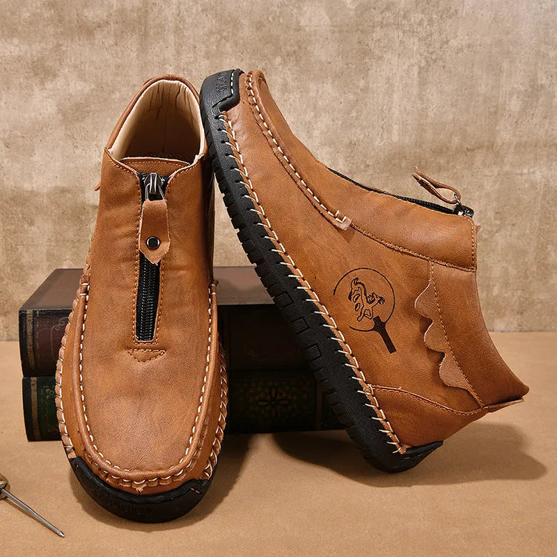 Men's black slip-on leather loafers with a round toe and low flat heel on a rubber sole.