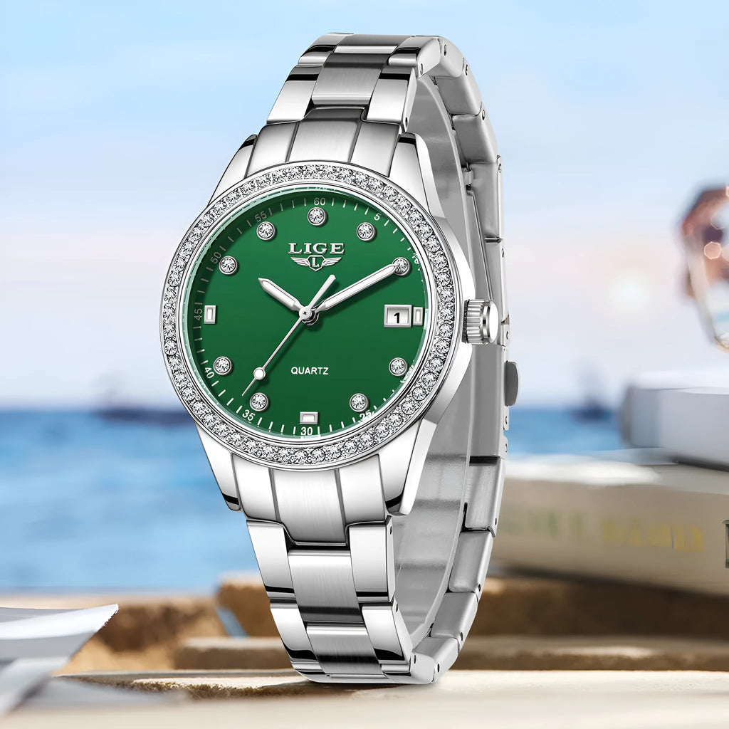 Women's silver fashion watch with diamond bezel, round white dial, luminous hands, and stainless steel bracelet.
