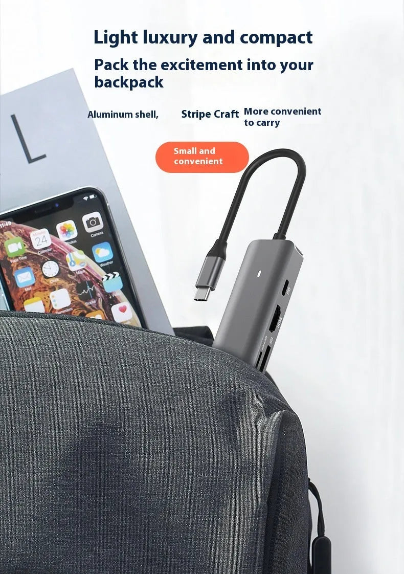 7-in-1 USB-C multi-port hub with SD card slot, microSD slot, three USB ports, and PD charging port.