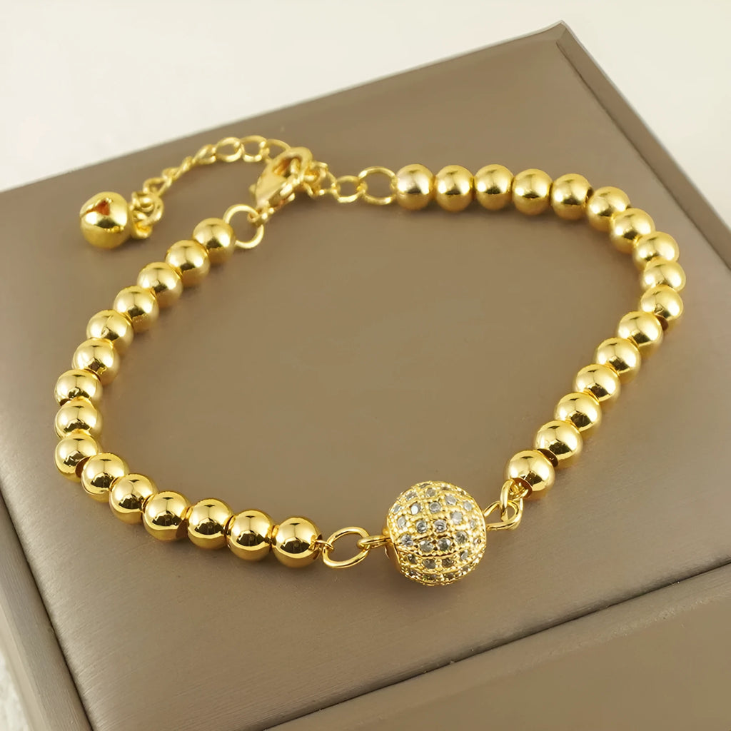 Close-up of a women's copper bracelet with a heart shape and a single round zircon stone in an Arabic-style design.