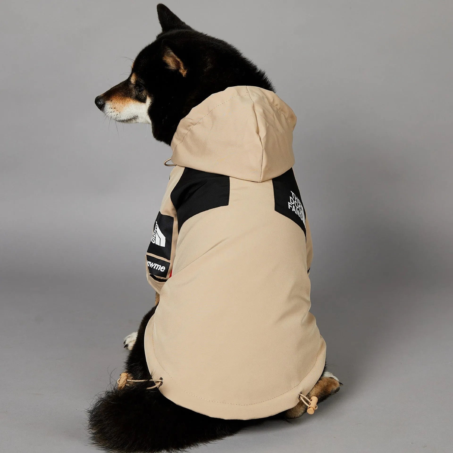 Khaki coloured polyester dog shell jacket for medium and large breeds on a mannequin.