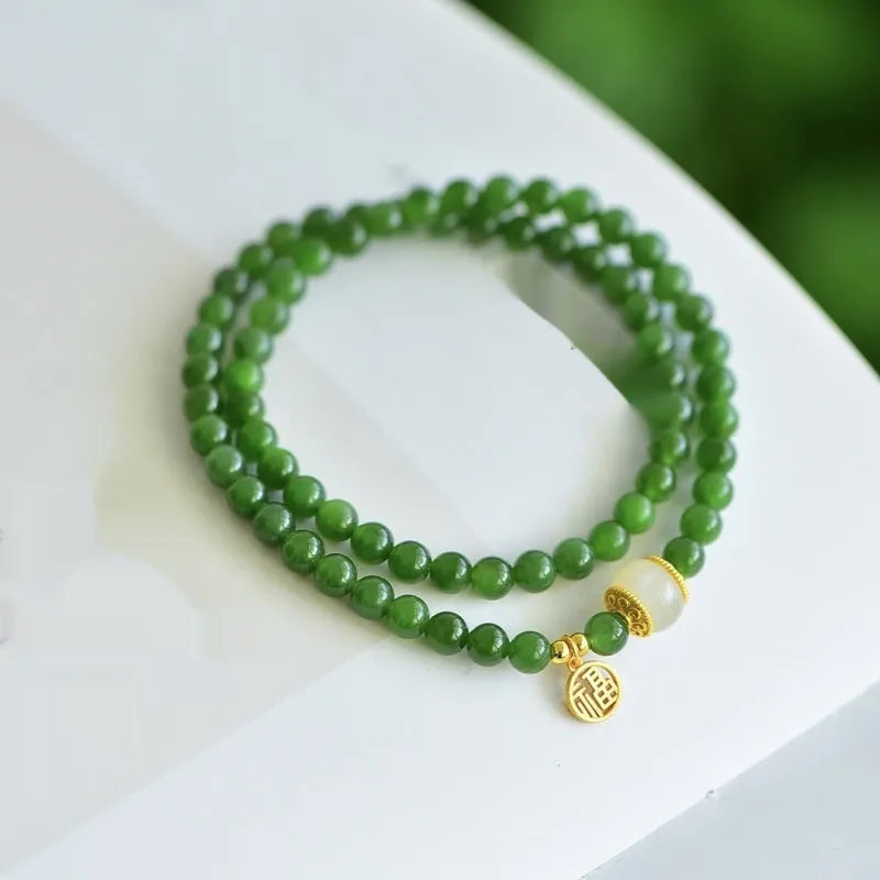 Women's double circle bracelet made from natural Hetian jade with 6mm geometric beads and a fu charm.