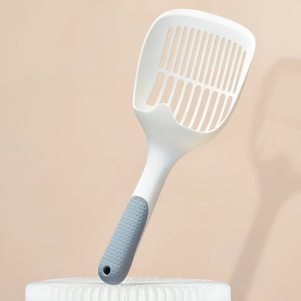 White plastic cat litter scoop with attached storage base on a white background.