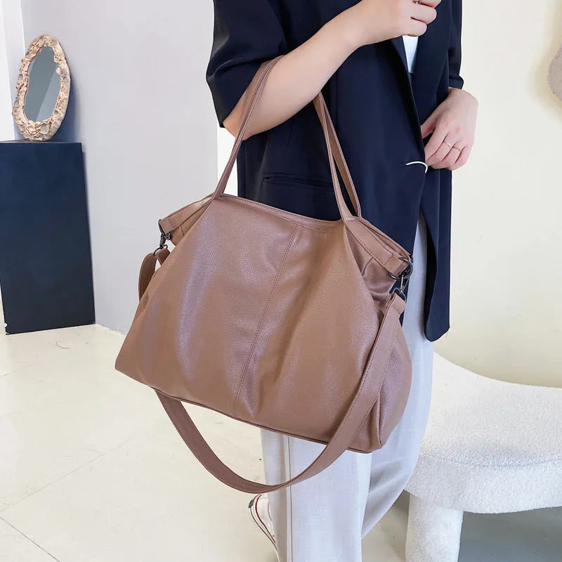 Large khaki soft PU messenger bag with long strap, shown open with internal phone and zipper pockets.