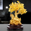 Citrine coloured resin turtle money tree Chinese style ornament on display.