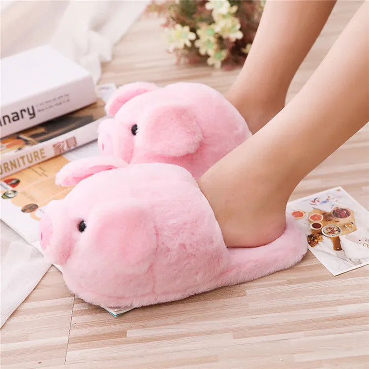 Pink pig-themed plush floor slippers for adults on a white background