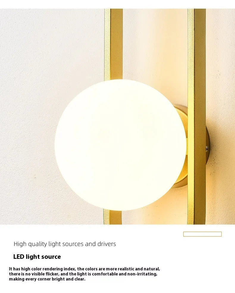 Minimalist black iron wall lamp with a glass shade mounted on a white wall.
