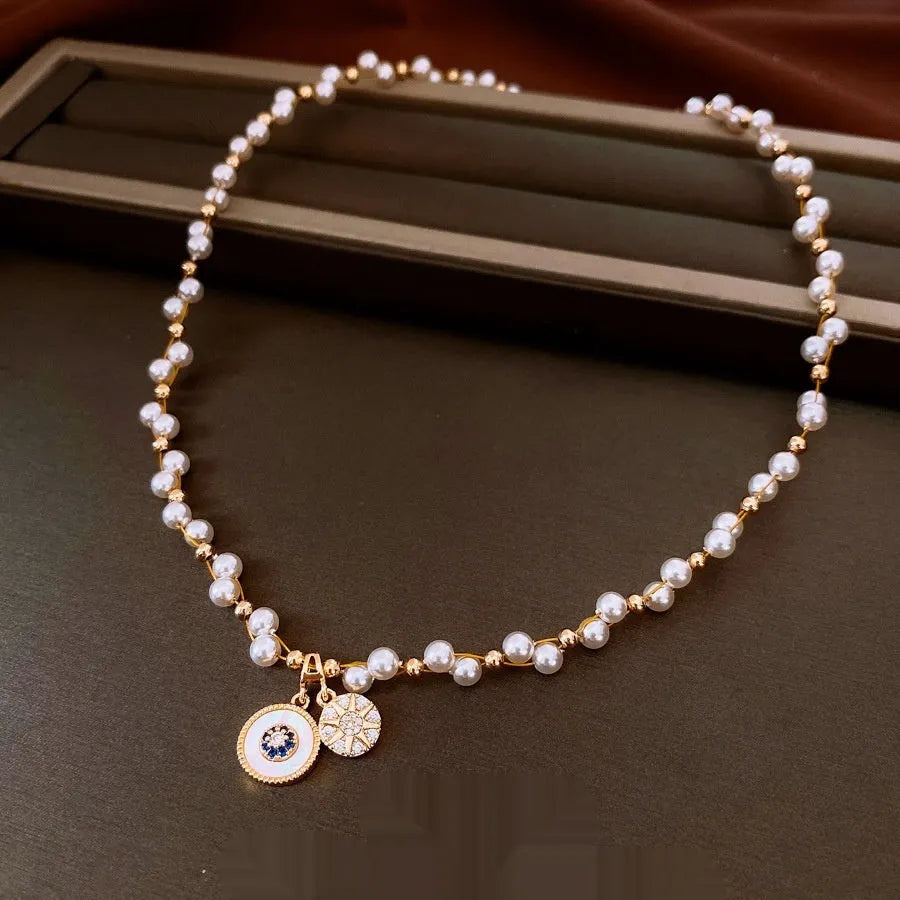 Gold plated clavicle necklace with round imitation pearl and zircon pendant on a 41-50cm chain.