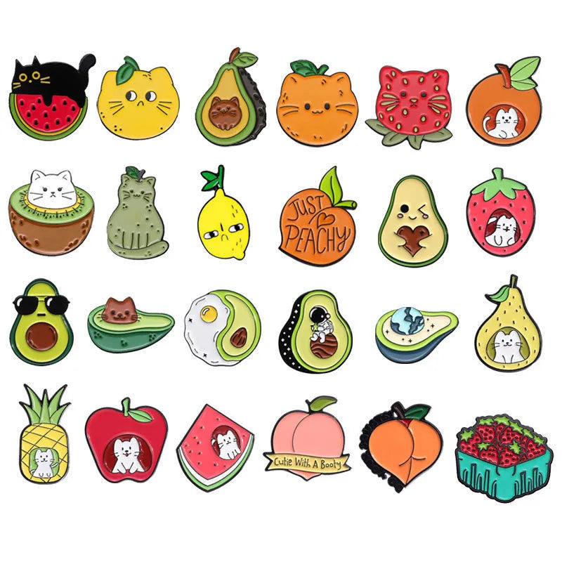 Colourful cartoon fruit and letter design on a metal brooch pin with a secure clasp.