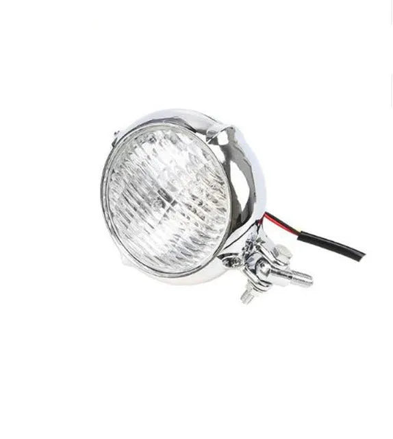 Black circular aluminium Harley-style motorcycle headlight with a coloured glass lens.