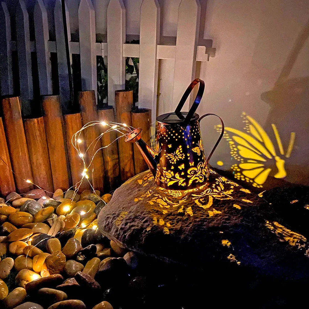 Solar-powered iron garden lamp with a tapered butterfly design emitting warm white LED light.
