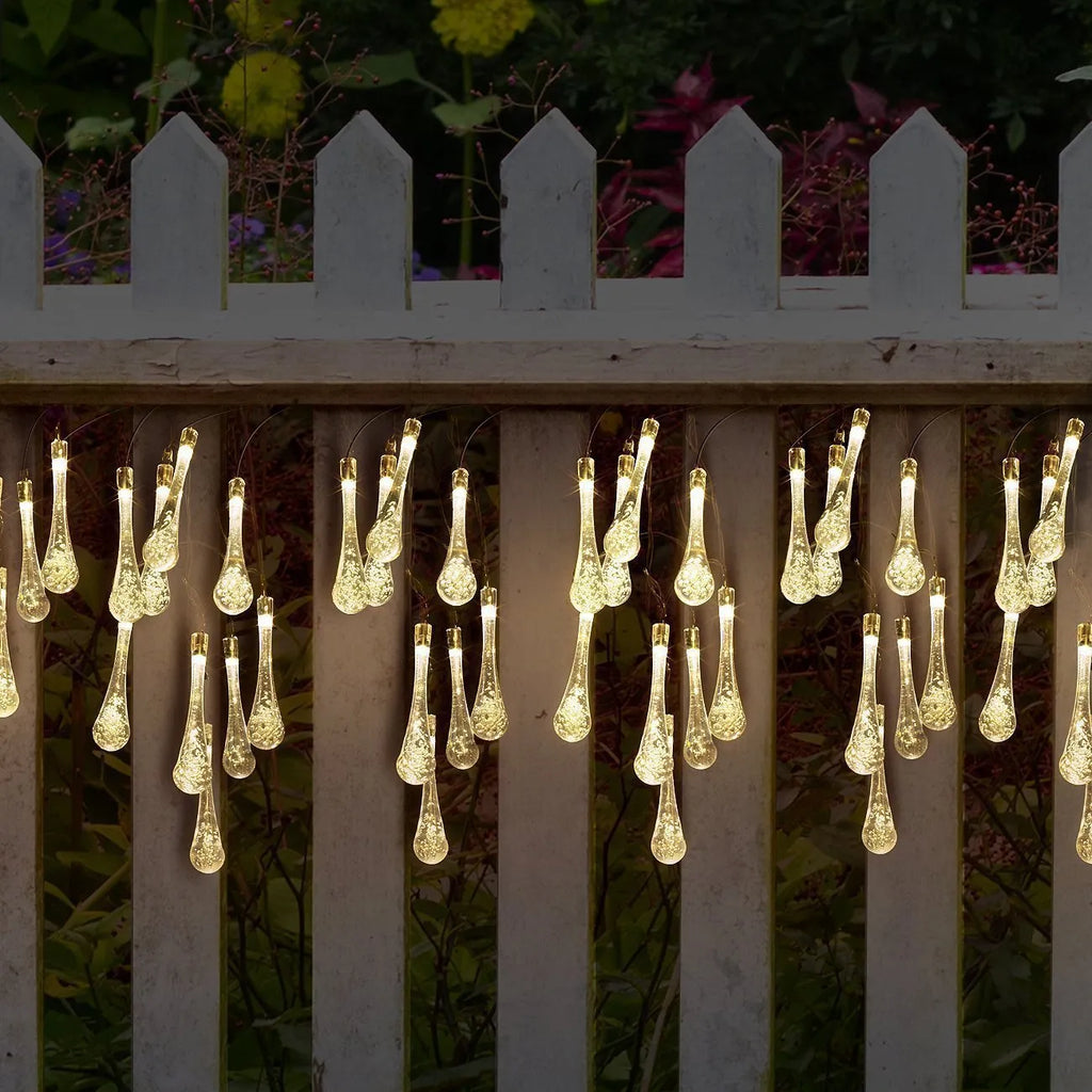 Solar-powered outdoor LED string lights with water drop shaped pendants on a 6.5 metre cable.