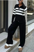 Women's black and white striped knitted polo collar two-piece set with long sleeves and trousers.