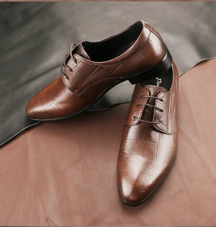 Men's black leather derby shoes with pointed toe and rubber sole on a white background.