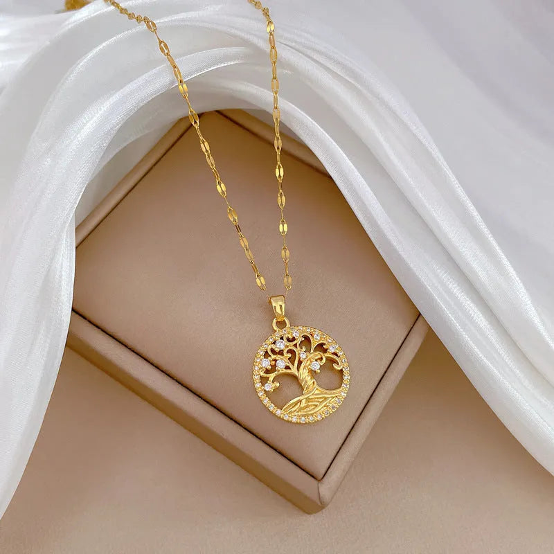 Gold-plated lucky tree pendant necklace with rhinestone zircons and mother of pearl on an adjustable chain.