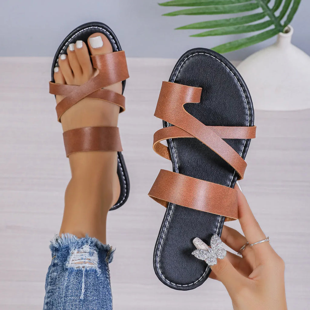Round-toe beach slippers with hollow-out design in black, brown, and wine red colours.