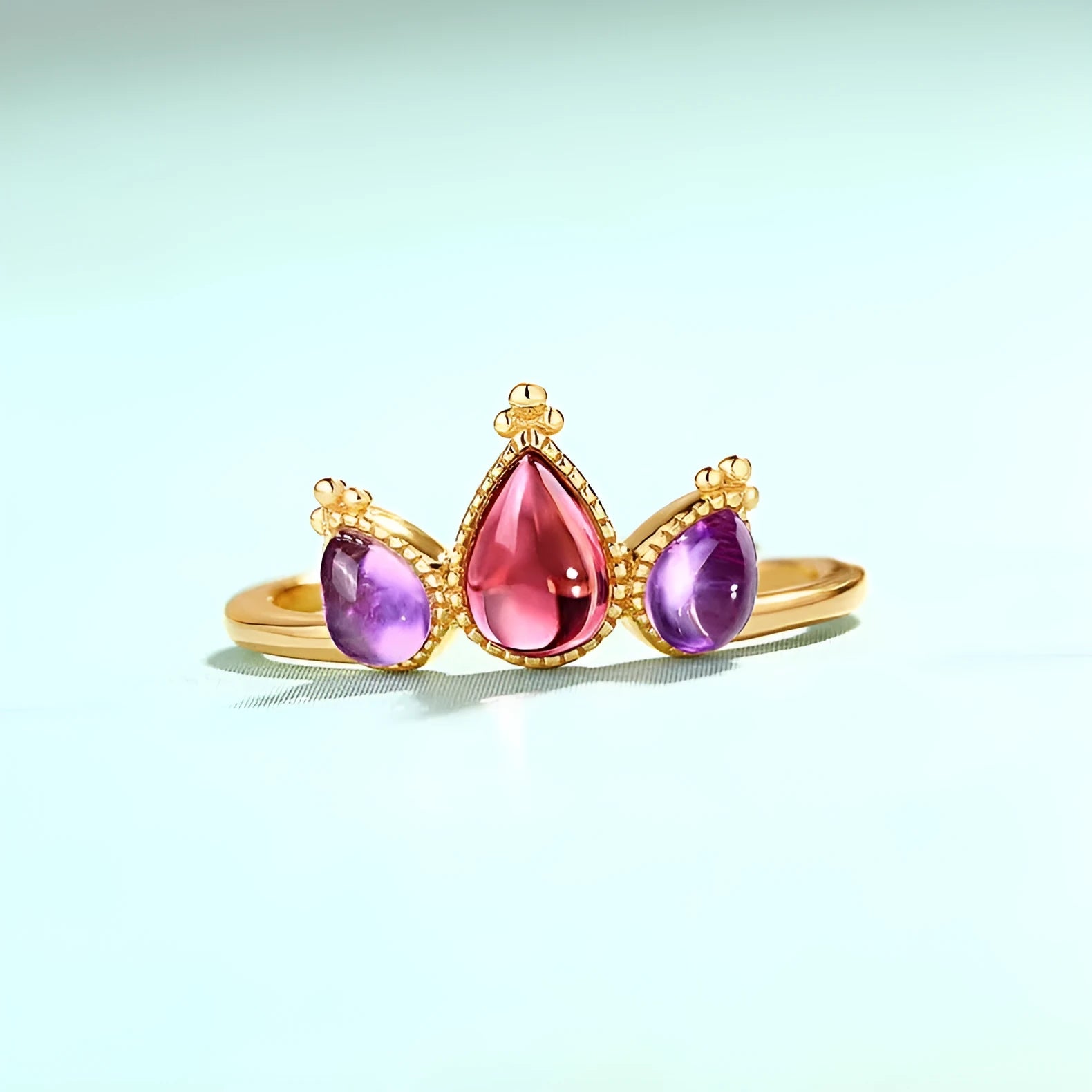Sterling silver ring with drop-shaped garnet stone on finger, 925 silver, electroplated finish