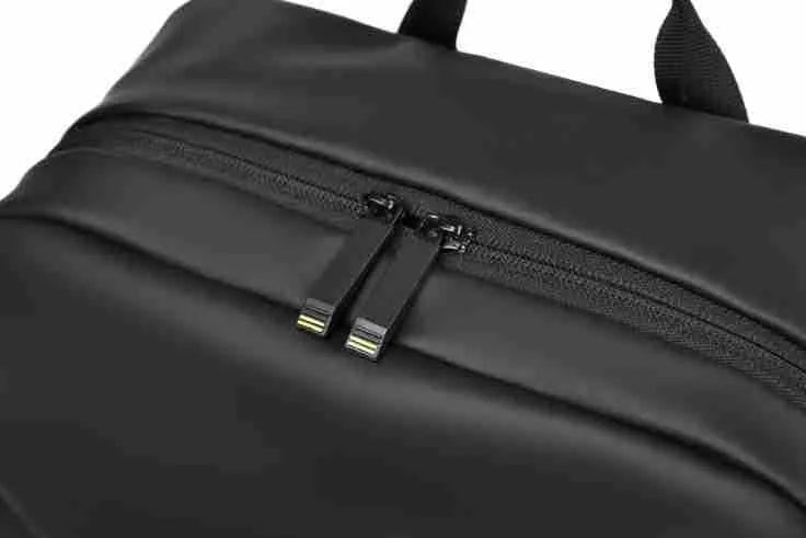 Large waterproof backpack in black, blue, or grey with PU leather construction and computer compartment