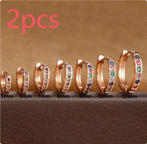 A pair of perforated circular stud earrings with zircon detailing in gold, rose gold, or silver colour.