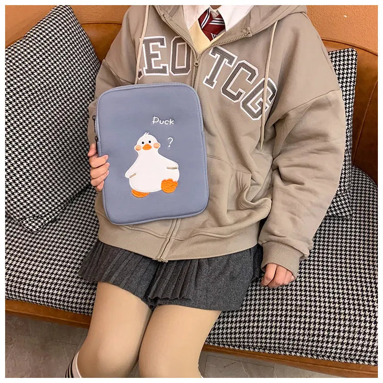 Blue cotton iPad case with embroidered cartoon duck design and a zipper.