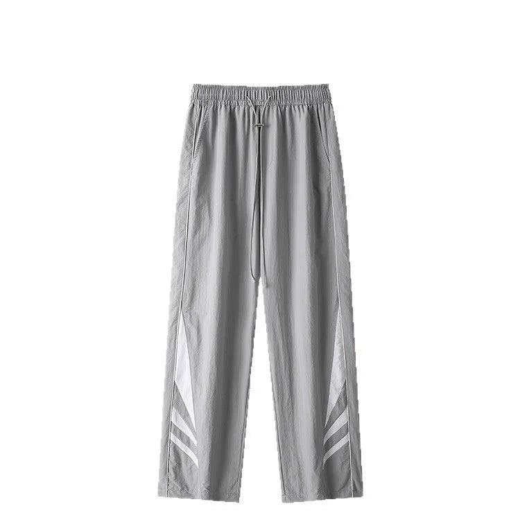 Men's loose fit straight-leg trousers in black, featuring an elasticated waist and button fly.