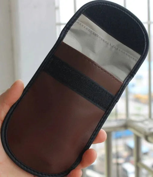 Black microfiber Faraday cage pouch for car key fob and RFID card protection.