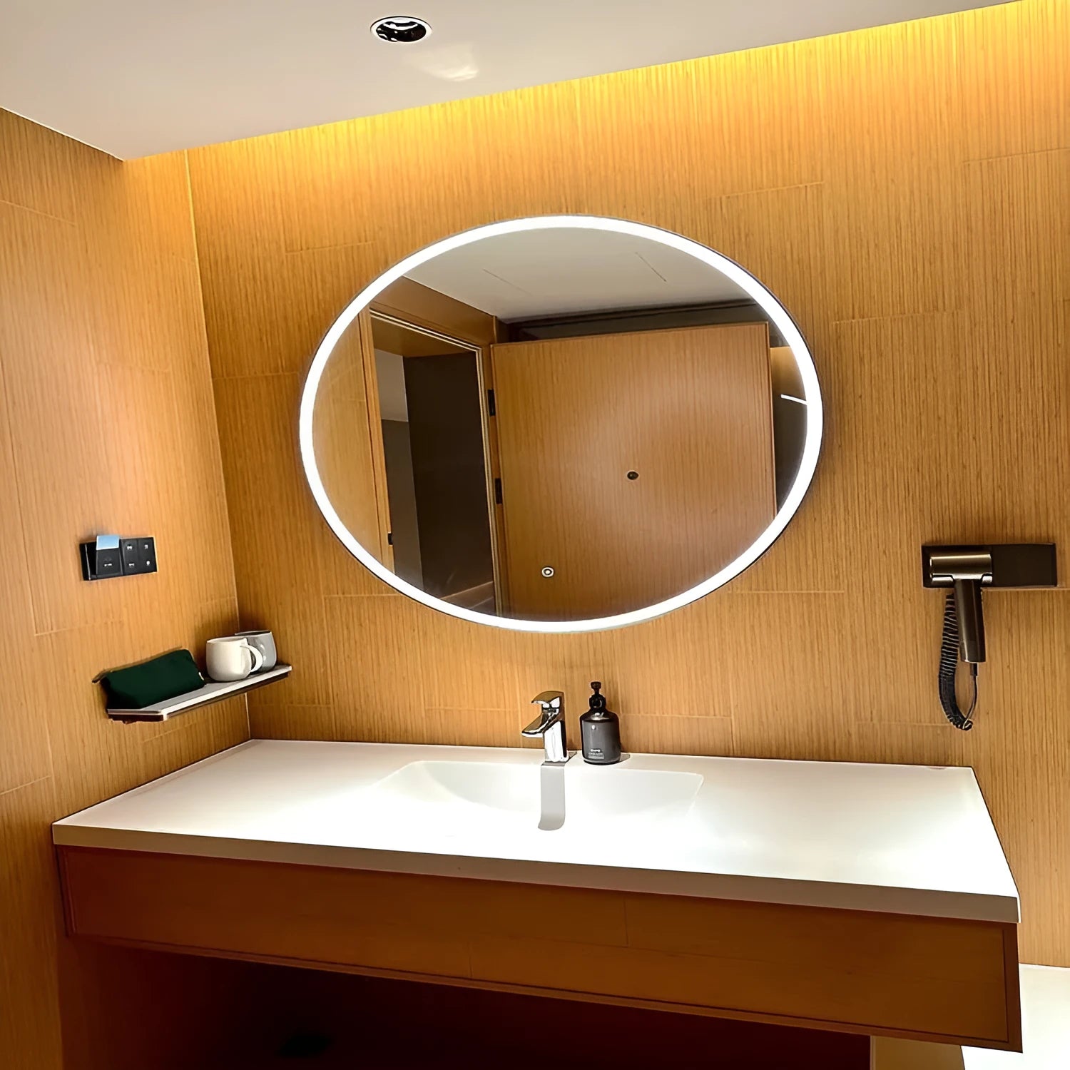 Round black aluminium alloy smart bathroom mirror with integrated LED lighting on a wall.