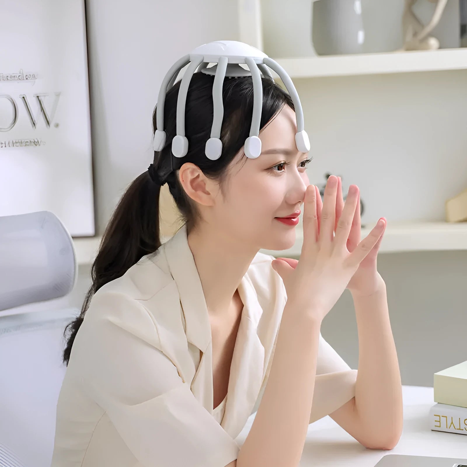 Black eight-claw head massager with flexible silicone tips and USB cable.