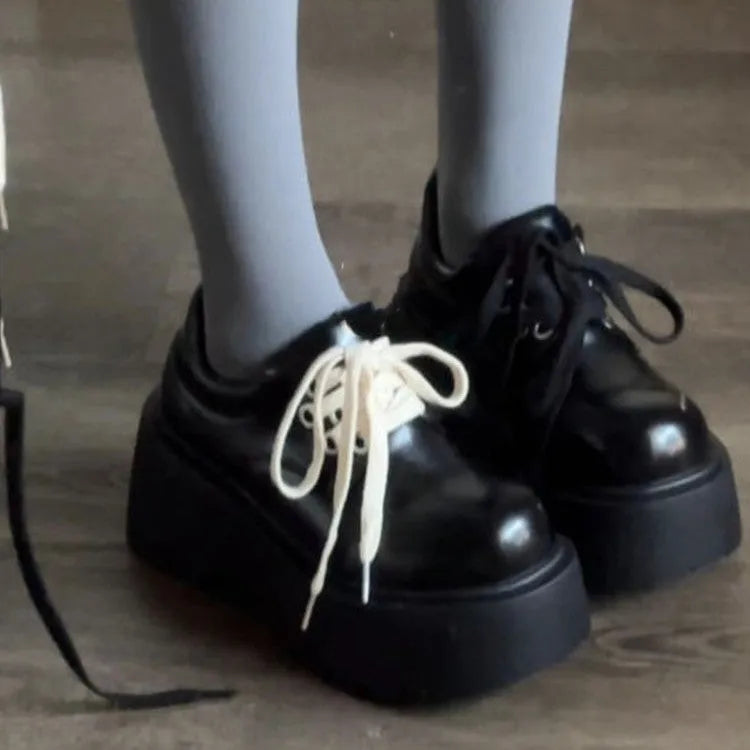 Matte black women's lace-up shoes with a high English muffin heel and thick rubber sole.