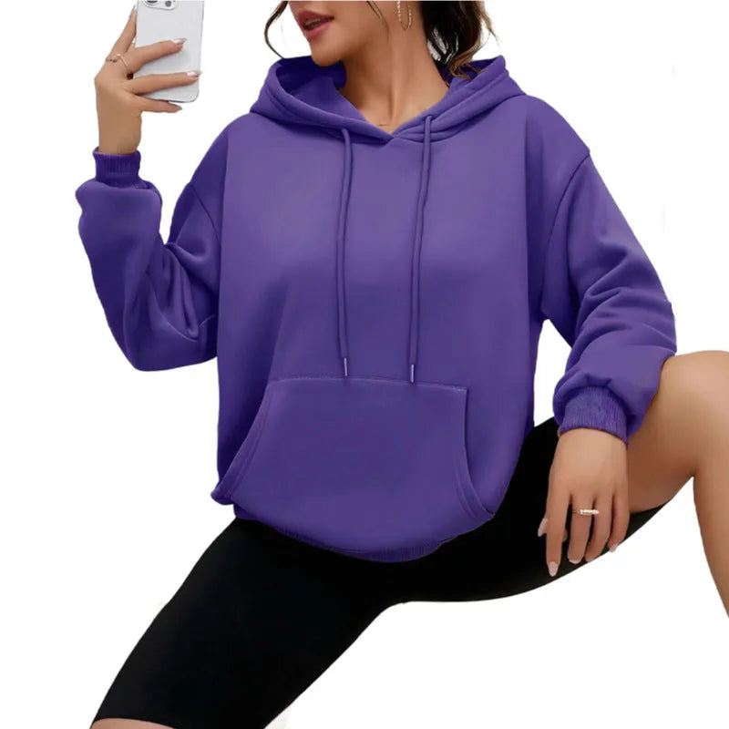 Women's loose grey sweatshirt with long sleeves and a front drawstring pocket.