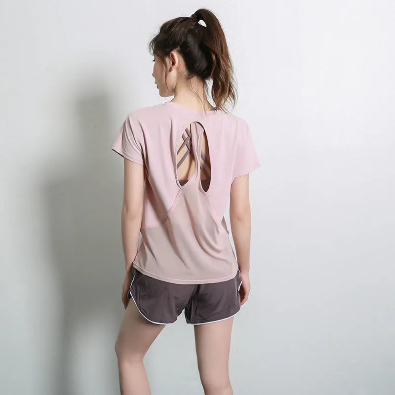 Women's short sleeve polyester sports t-shirt in pink, shown for running and fitness.