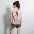 Women's short sleeve polyester sports t-shirt in pink, shown for running and fitness.