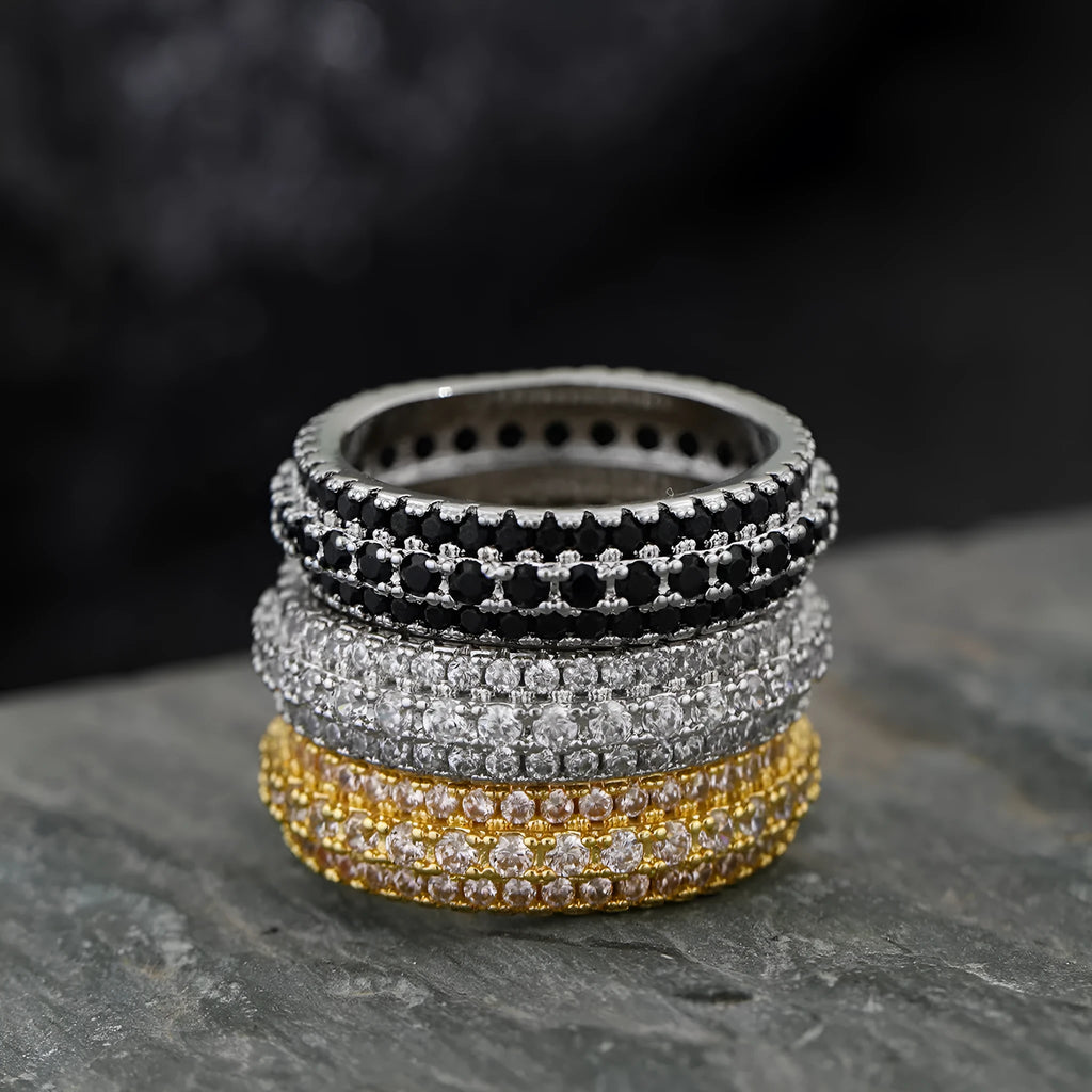 A geometric triangle-shaped ring with a zircon stone inlay, shown in a choice of metal colour finishes.