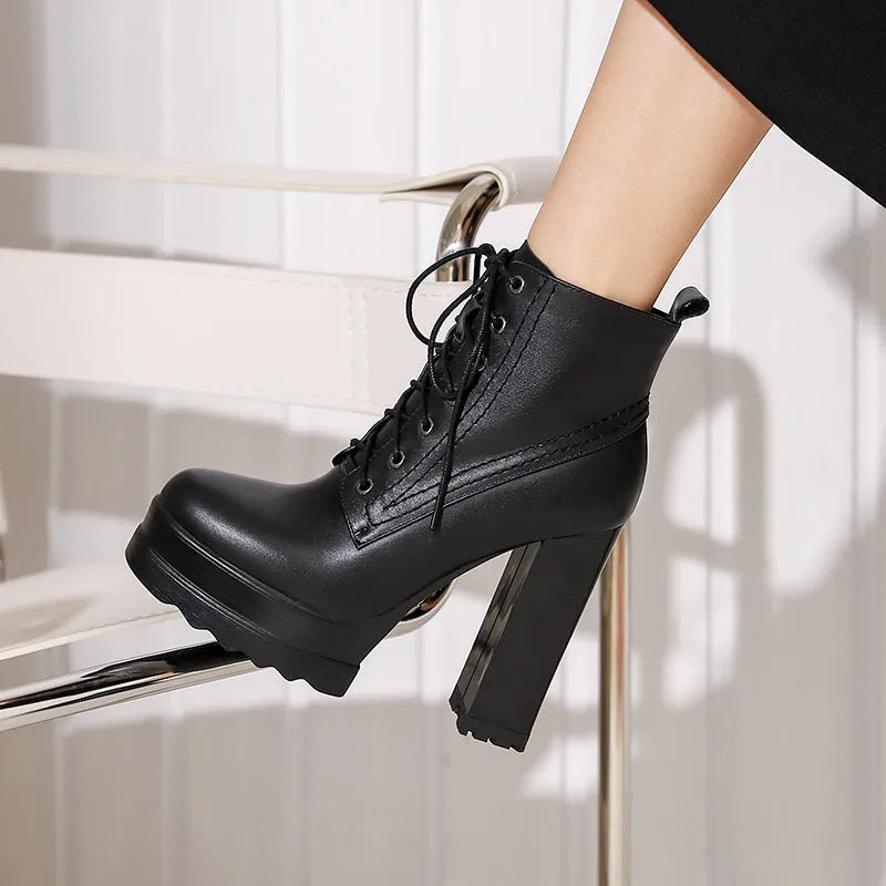 Women's black chunky heel waterproof ankle boots with a side zip on a white background.
