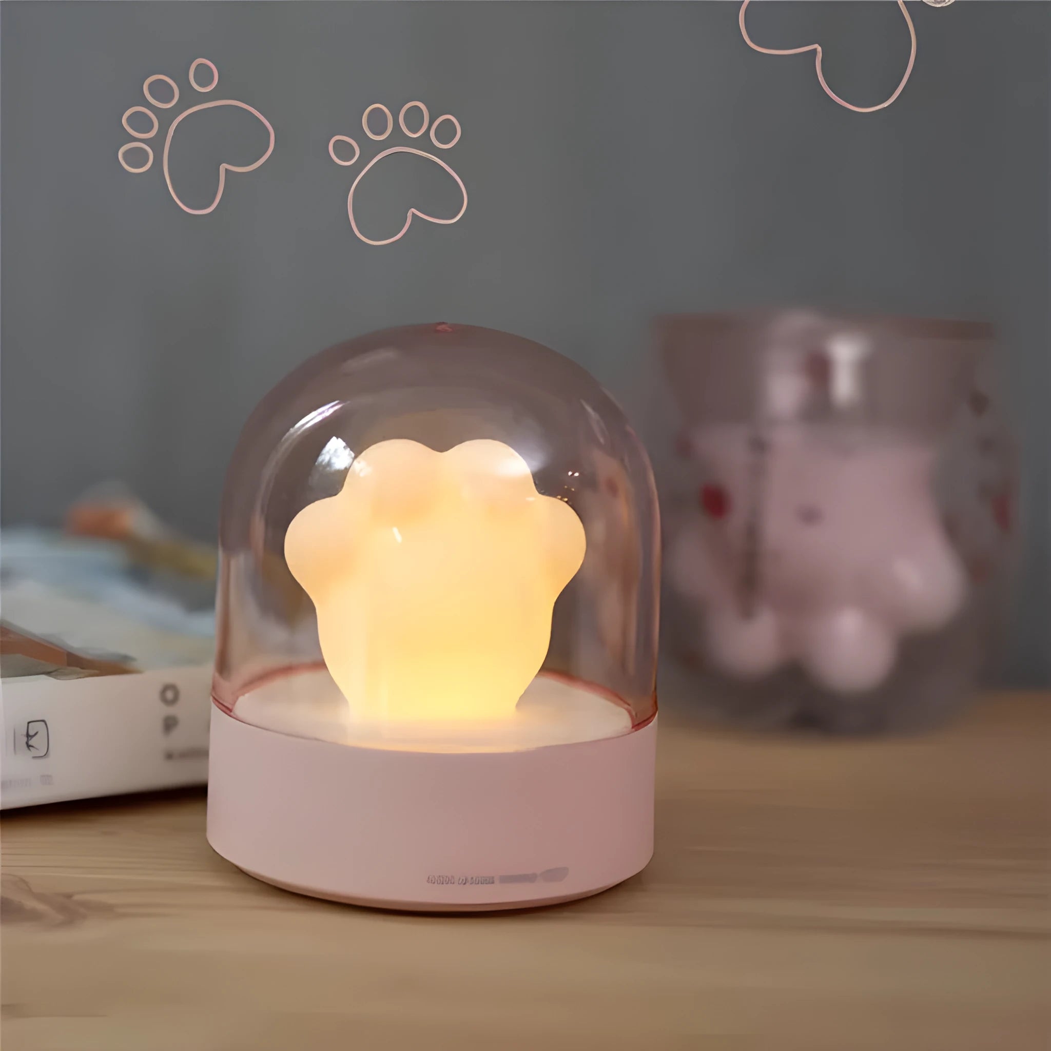 Grey cat paw shaped USB rechargeable night light with musical features on wooden desk