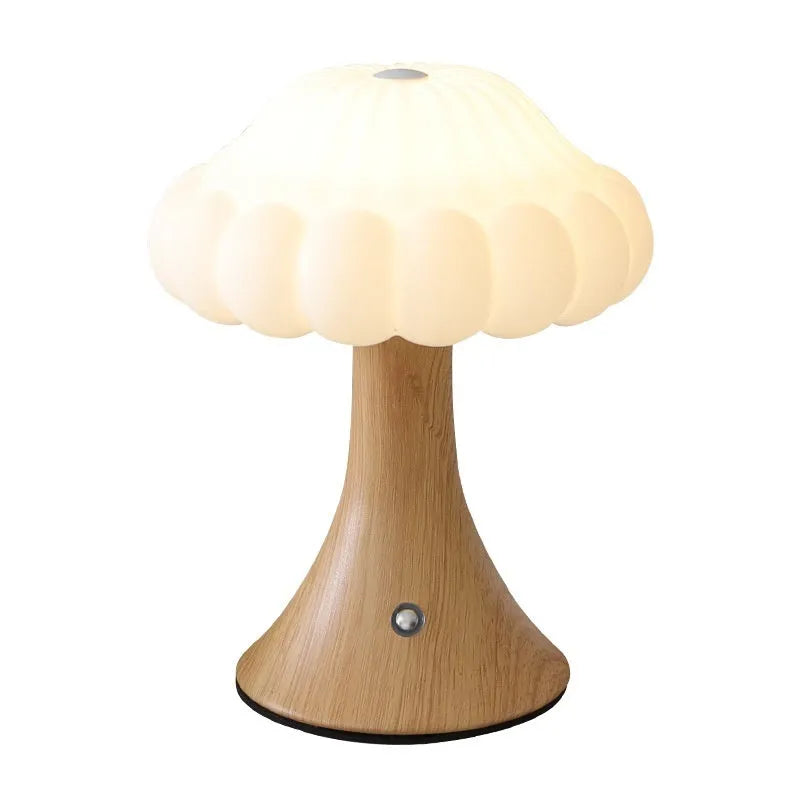 Small mushroom-shaped night lamp on a charging base in wood grain colour finish.