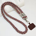 Woven nylon crossbody phone lanyard with macaron pendant in Pink Dot Gray, showing three-strand horse tail detail and matching clip.